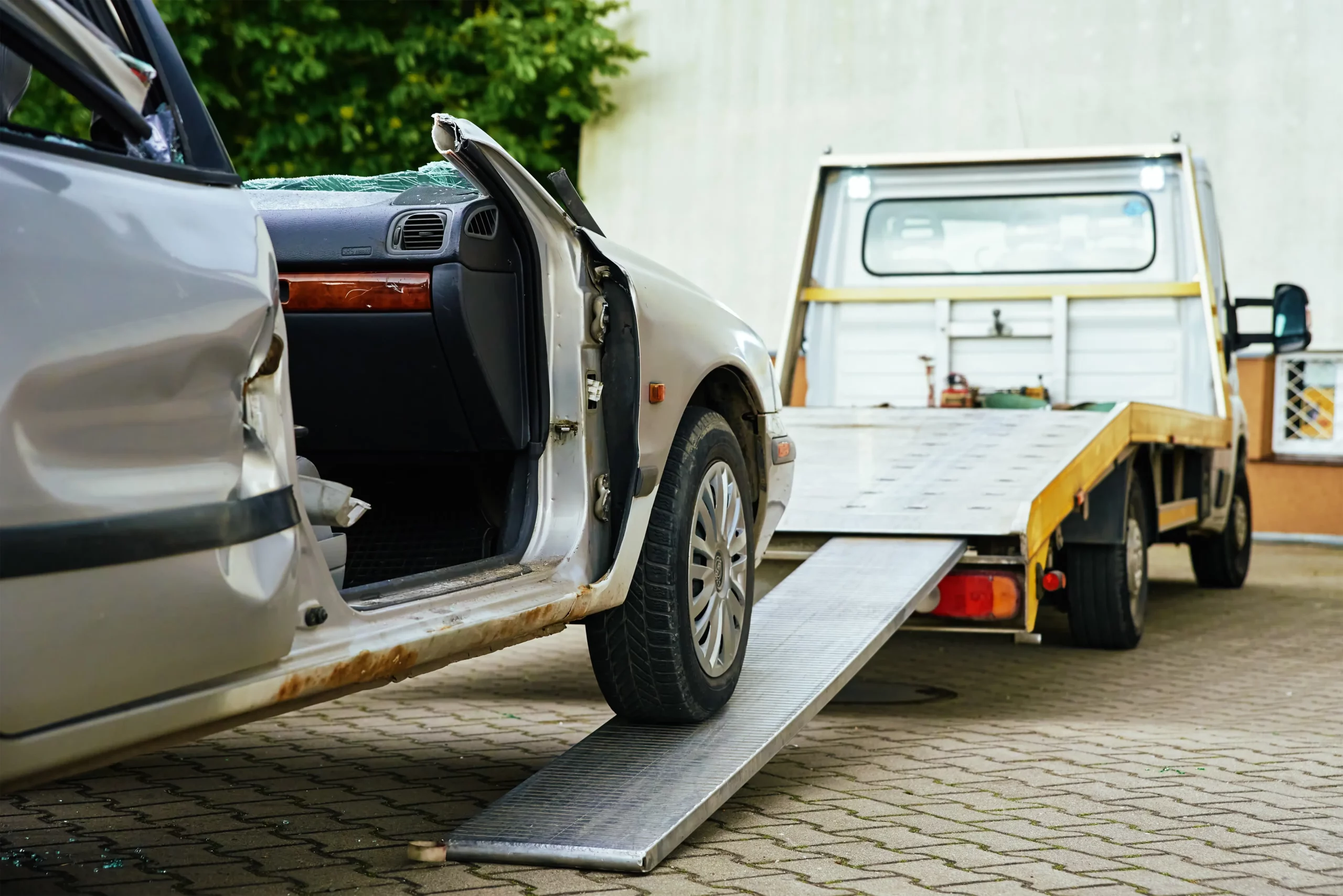 crashed car loading into a tow truck after a traffic accident