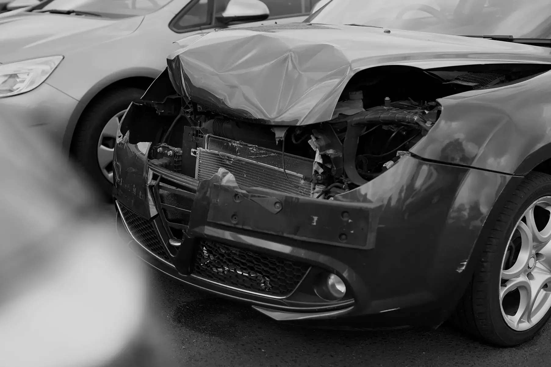 A man and his vehicle pulled over to the side of the road after a car accident.